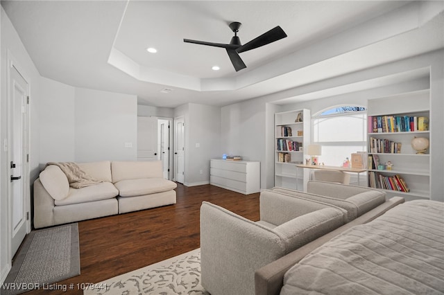 bedroom featuring recessed lighting, a raised ceiling, a ceiling fan, wood finished floors, and baseboards