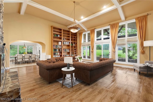 1808 Bramble Brae St, Fort Smith, AR 72908 - living area with arched walkways, wood finished floors, beamed ceiling, healthy amount of natural light, and a high ceiling