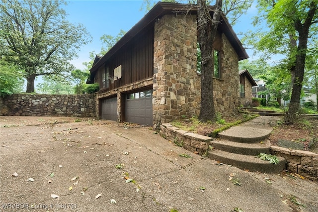1808 Bramble Brae St, Fort Smith, AR 72908 - view of home's exterior with a garage, concrete driveway, and stone siding
