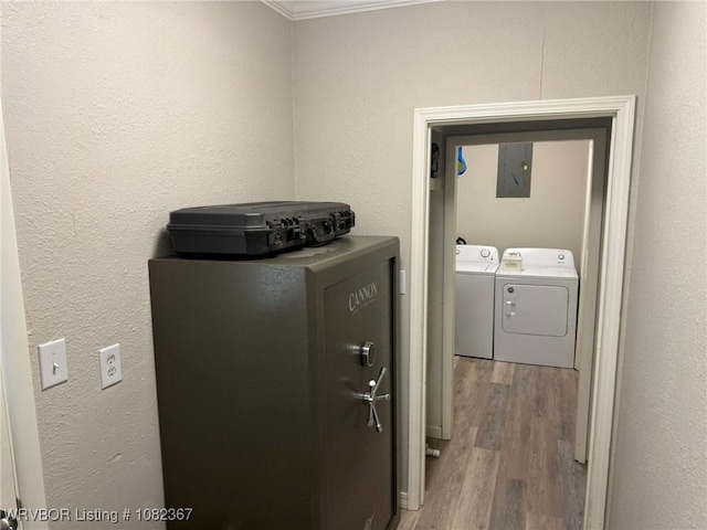 309 N 25th St, Ozark, AR 72949 - laundry room featuring washer and clothes dryer, electric panel, wood finished floors, and ornamental molding