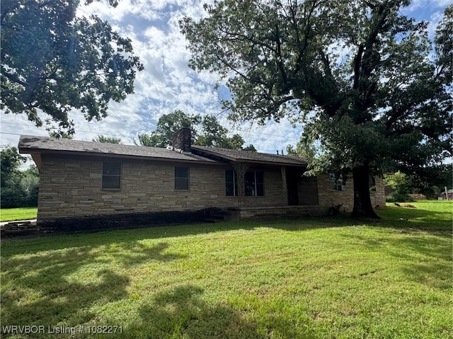 3928 N 59th Hwy, Van Buren, AR 72956 - rear view of house featuring stone siding, a chimney, and a yard