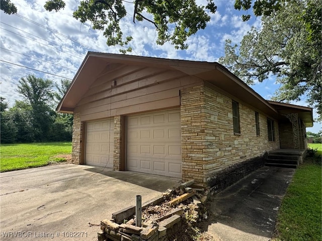 3928 N 59th Hwy, Van Buren, AR 72956 - view of side of home with driveway, stone siding, and a garage