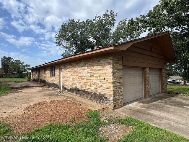 3928 N 59th Hwy, Van Buren, AR 72956 - view of side of home featuring stone siding and a garage