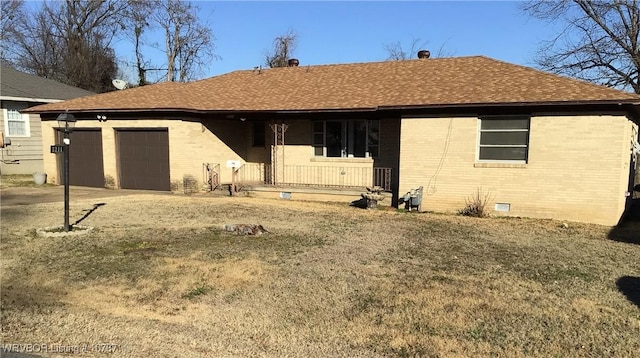 rear view of house featuring a garage and covered porch