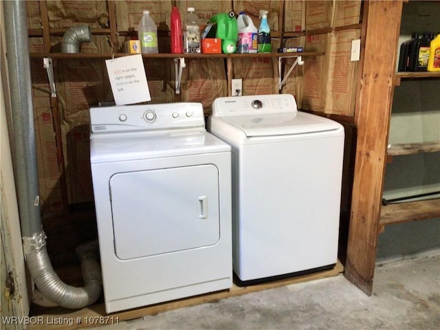 clothes washing area featuring washer and dryer and laundry area
