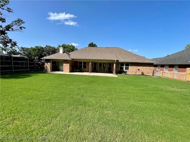 4104 Glen Flora Way, Fort Smith, AR 72908 - back of house featuring a patio, a chimney, brick siding, and roof with shingles