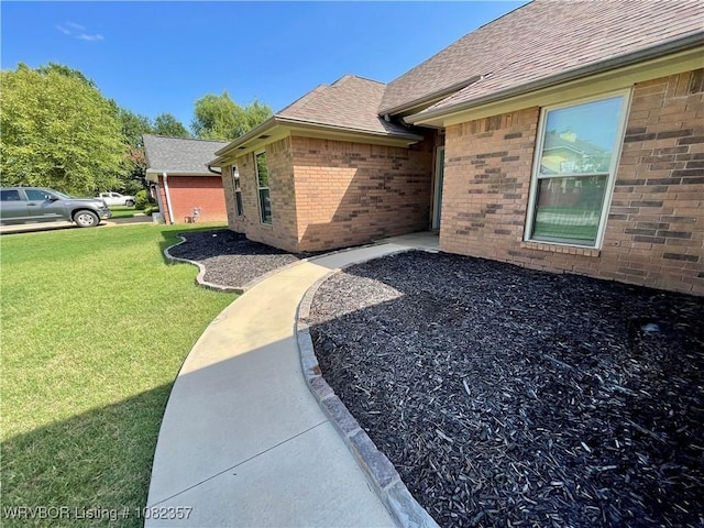 4104 Glen Flora Way, Fort Smith, AR 72908 - property entrance featuring a yard, brick siding, and roof with shingles
