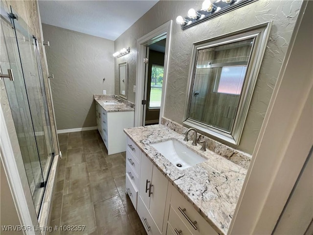4104 Glen Flora Way, Fort Smith, AR 72908 - full bath featuring a textured wall, a stall shower, and two vanities