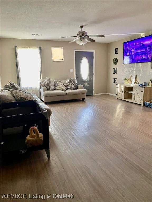 1111 Bluebird Dr, Cedarville, AR 72932 - living area featuring ceiling fan, baseboards, wood finished floors, and visible vents
