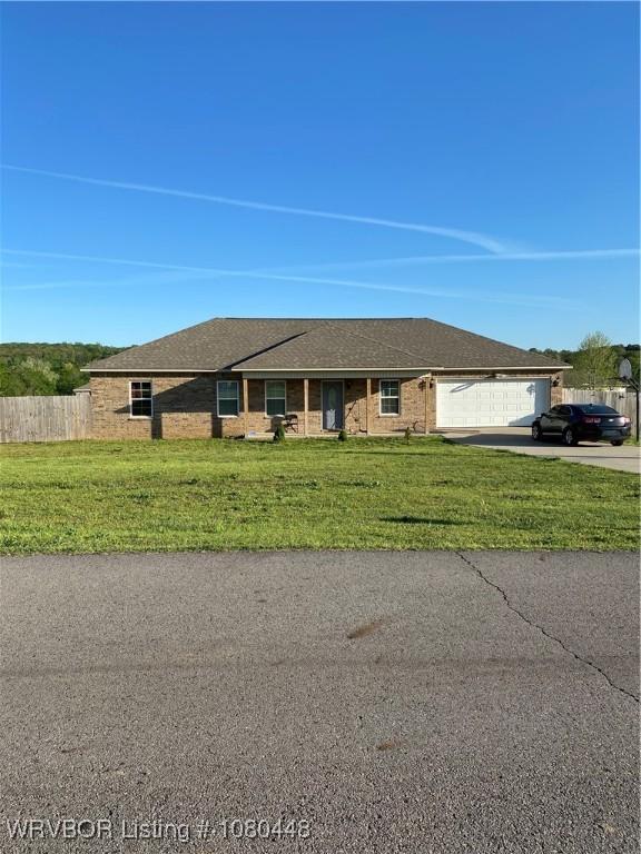1111 Bluebird Dr, Cedarville, AR 72932 - ranch-style house with an attached garage, a front lawn, concrete driveway, and fence