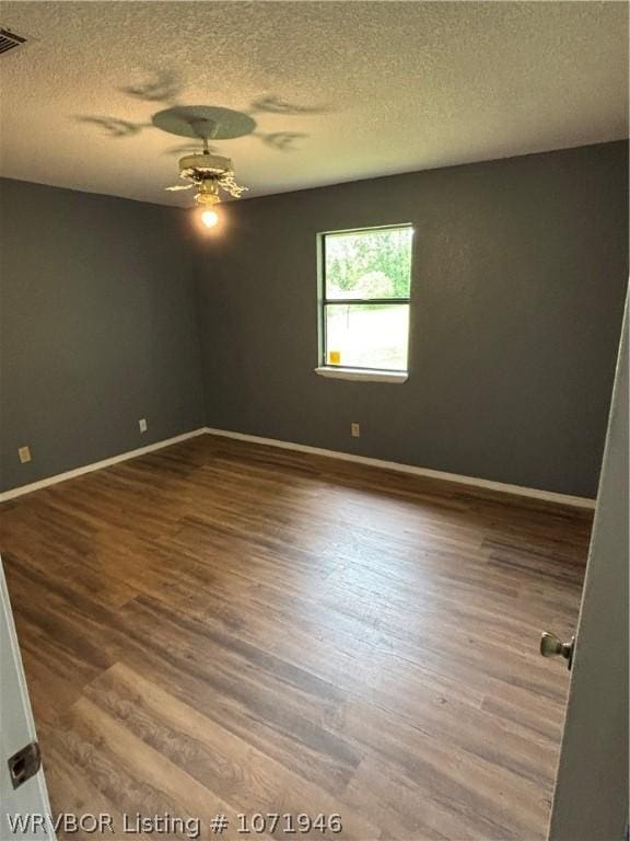 unfurnished room featuring hardwood / wood-style floors, a textured ceiling, and ceiling fan