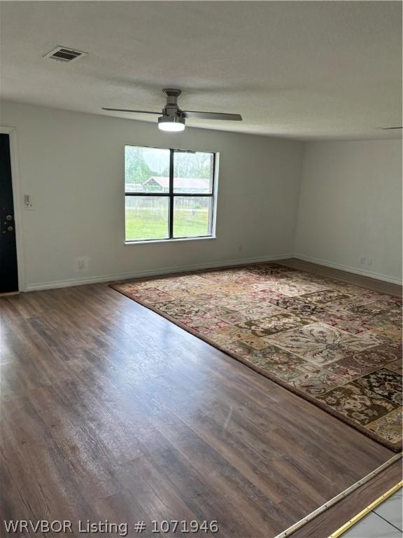 unfurnished room featuring hardwood / wood-style flooring and ceiling fan