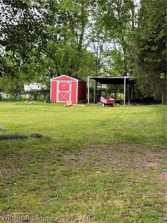 view of yard with a carport and a storage shed