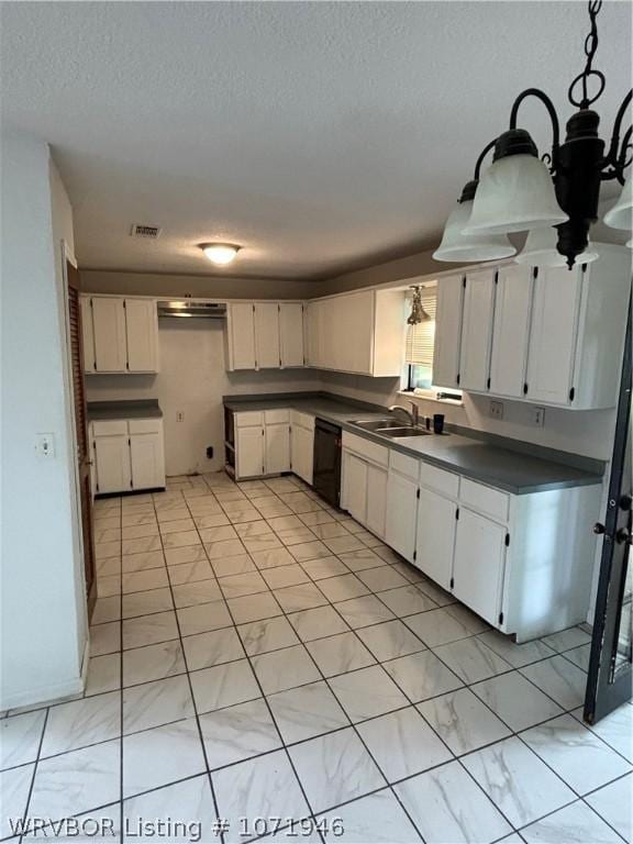 kitchen with white cabinets, dishwasher, sink, and a textured ceiling