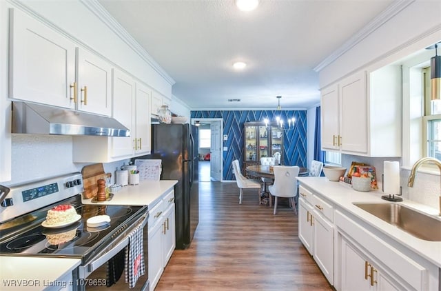 kitchen with wallpapered walls, under cabinet range hood, ornamental molding, stainless steel electric range, and a sink