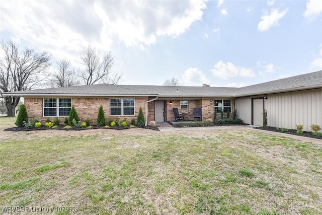 single story home with brick siding, an attached garage, and a front lawn