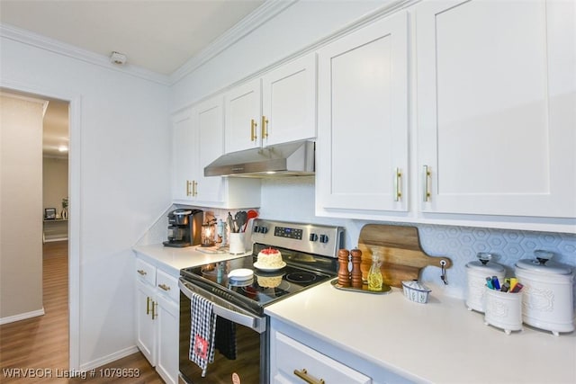 kitchen featuring ornamental molding, light countertops, stainless steel range with electric stovetop, white cabinets, and under cabinet range hood