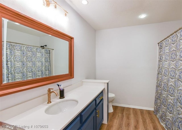 full bath with recessed lighting, toilet, vanity, and wood finished floors