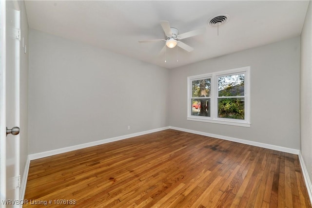 empty room featuring ceiling fan and hardwood / wood-style flooring