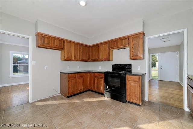 kitchen featuring black electric range oven and a healthy amount of sunlight