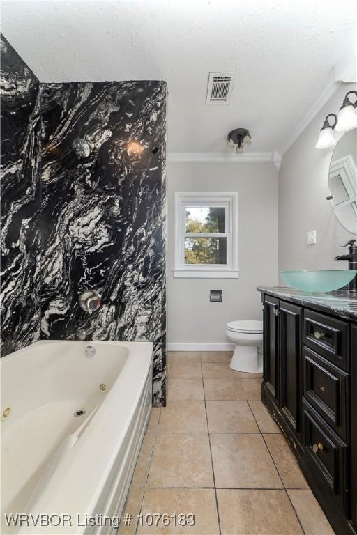 bathroom featuring tile patterned flooring, vanity, toilet, and crown molding