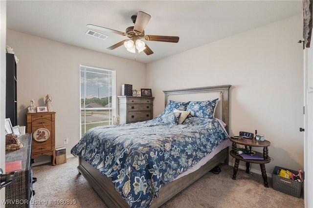 carpeted bedroom with ceiling fan and baseboards