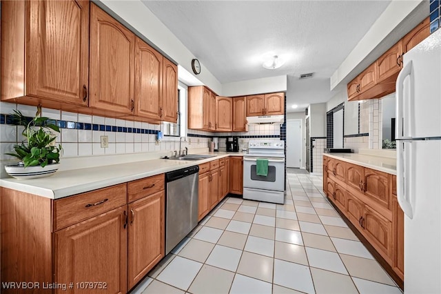 8437 Sebastian Lake Dr, Hackett, AR 72937 - kitchen with a sink, decorative backsplash, white appliances, light countertops, and under cabinet range hood