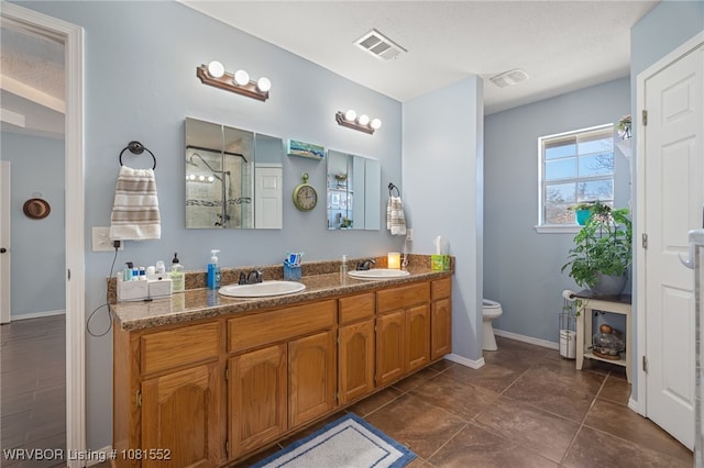 2027 High Meadow Ln, Alma, AR 72921 - bathroom with double vanity, toilet, a shower, baseboards, and tile patterned floors