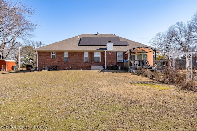 2027 High Meadow Ln, Alma, AR 72921 - back of house featuring solar panels, a pergola, a lawn, and brick siding