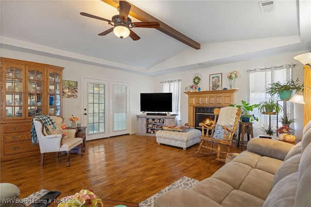 2027 High Meadow Ln, Alma, AR 72921 - living area with wood finished floors, a ceiling fan, and a lit fireplace