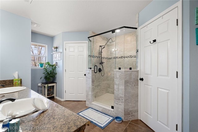 2027 High Meadow Ln, Alma, AR 72921 - full bath featuring a stall shower, tile patterned floors, double vanity, and baseboards