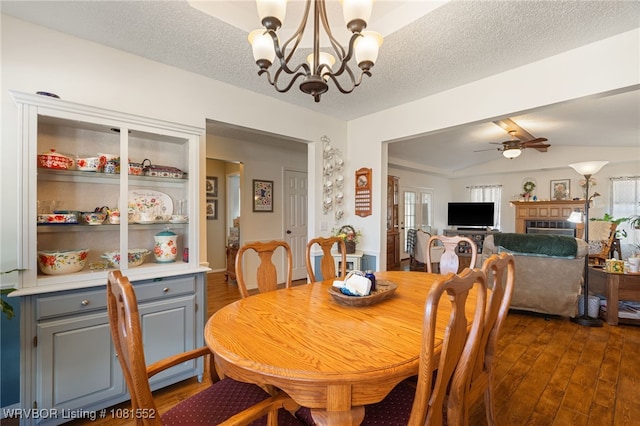 2027 High Meadow Ln, Alma, AR 72921 - dining room with vaulted ceiling, a chandelier, dark wood-style floors, healthy amount of natural light, and a ceiling fan