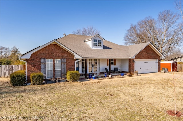 2027 High Meadow Ln, Alma, AR 72921 - view of front of house featuring brick siding, covered porch, driveway, a garage, and a shed