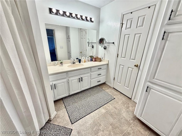 bathroom featuring tile patterned flooring and vanity