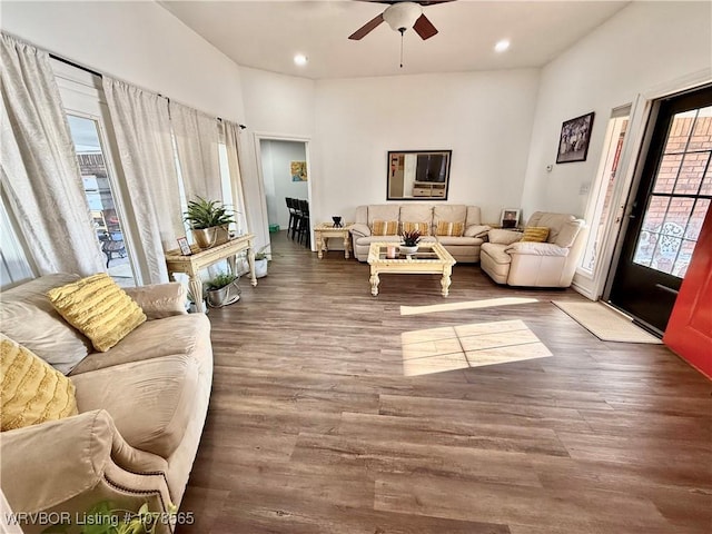 living room featuring hardwood / wood-style flooring, a healthy amount of sunlight, and ceiling fan