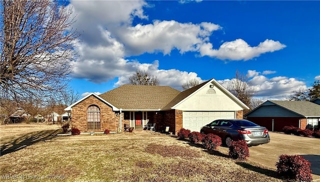 ranch-style home with a garage and a front yard