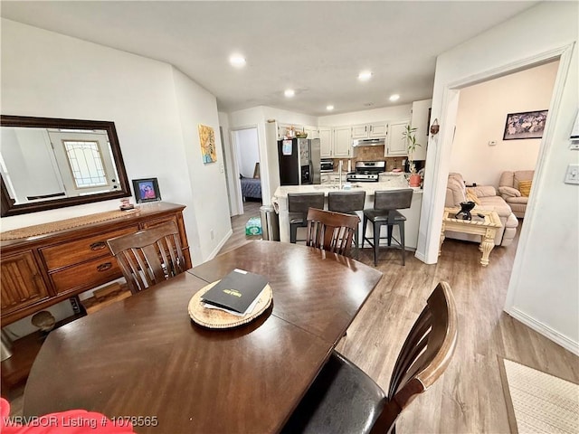 dining space with light wood-type flooring