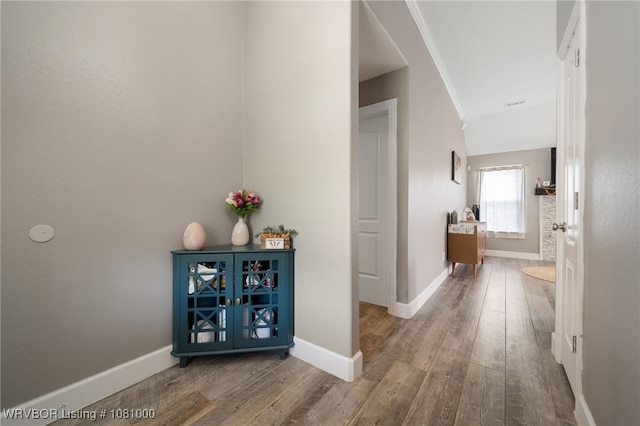 hall with wood finished floors and baseboards