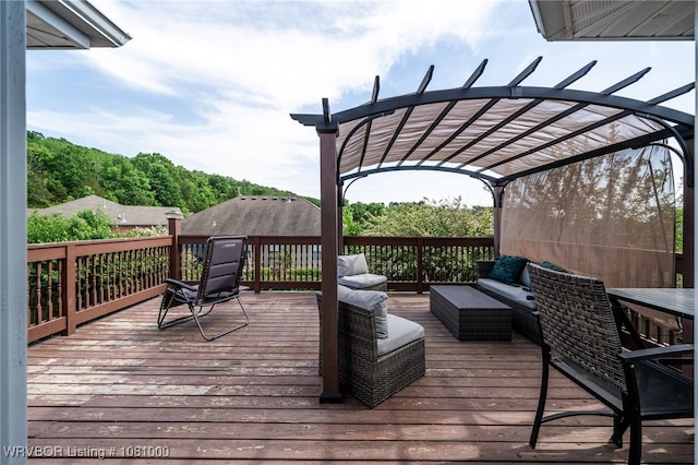 wooden deck with outdoor lounge area and a pergola