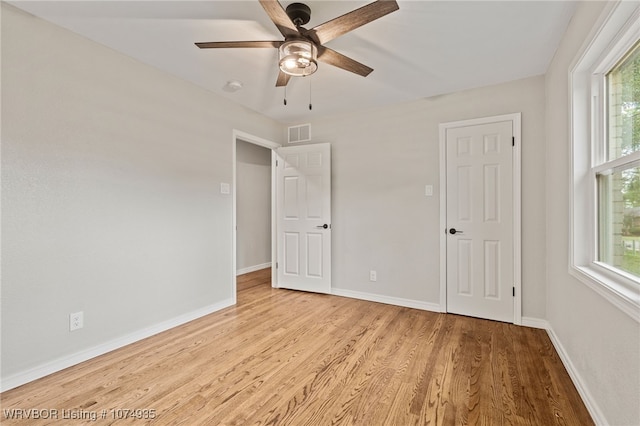 unfurnished bedroom with multiple windows, ceiling fan, and light hardwood / wood-style floors