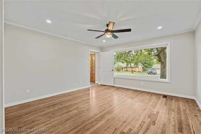 spare room with crown molding, light hardwood / wood-style flooring, and ceiling fan