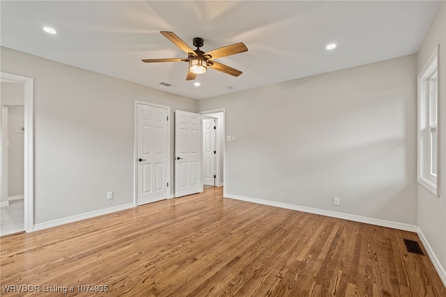 unfurnished bedroom featuring hardwood / wood-style floors and ceiling fan