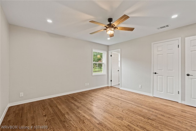 empty room featuring hardwood / wood-style flooring and ceiling fan