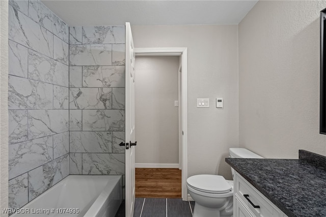 full bathroom featuring vanity, toilet, and tiled shower / bath