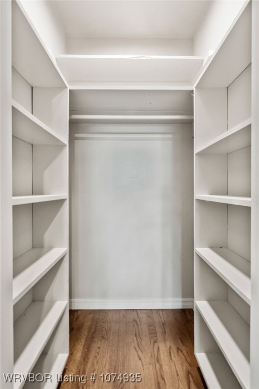 walk in closet featuring hardwood / wood-style floors