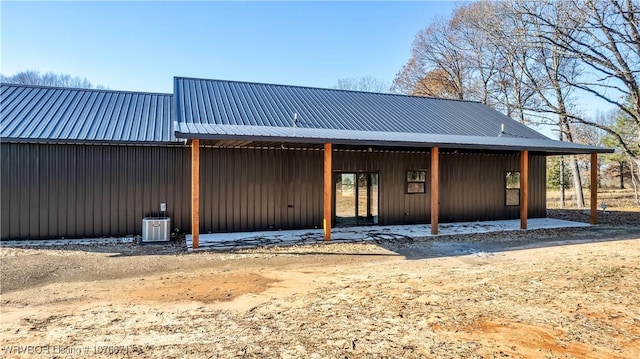 rear view of house with an outbuilding and cooling unit