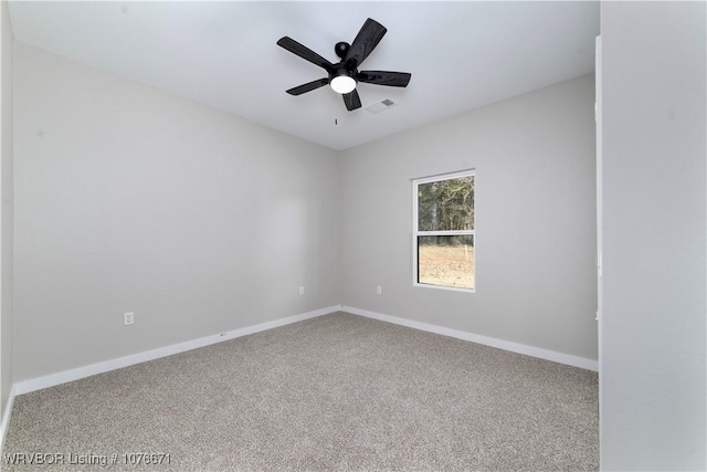 carpeted spare room with ceiling fan