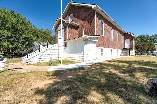 view of side of property with a yard