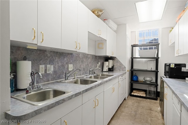 kitchen featuring backsplash, white cabinetry, and sink