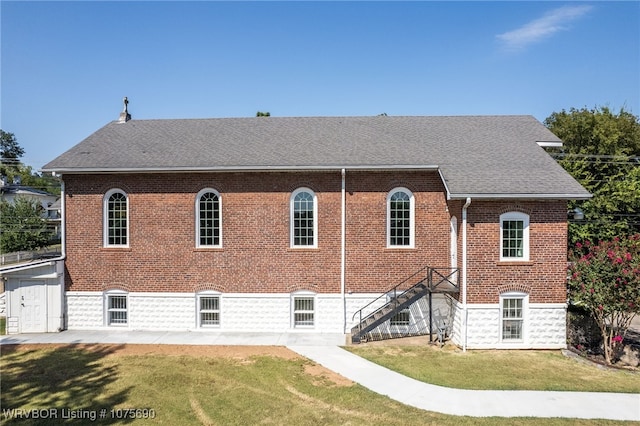 back of property featuring a lawn